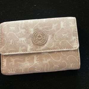 Tan and white wallet with little monkeys